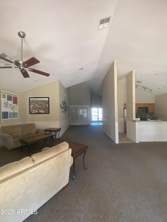 living area featuring lofted ceiling, ceiling fan, visible vents, carpet, and rail lighting