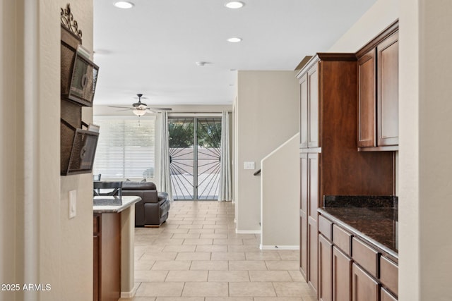 11048 E Quintana Ave, Mesa, AZ 85212 - kitchen with a ceiling fan, recessed lighting, open floor plan, dark stone counters, and light tile patterned flooring