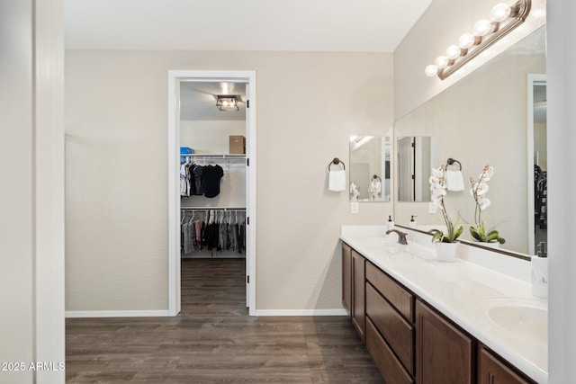 11048 E Quintana Ave, Mesa, AZ 85212 - bathroom with double vanity, wood finished floors, and a walk in closet