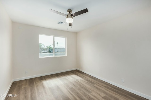 empty room featuring ceiling fan and hardwood / wood-style floors