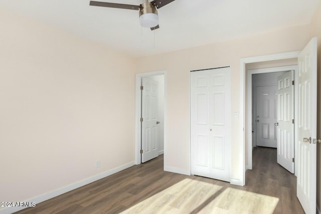 unfurnished bedroom featuring ceiling fan and dark wood-type flooring