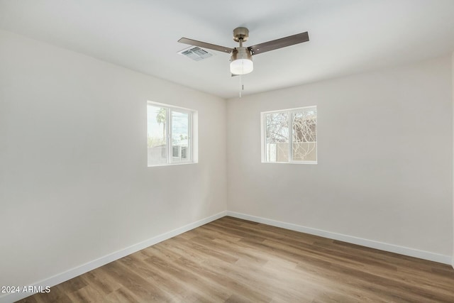 empty room with hardwood / wood-style flooring and ceiling fan