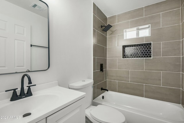 full bathroom with toilet, tiled shower / bath combo, and vanity