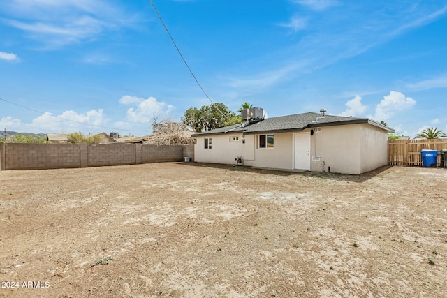 rear view of property with central AC