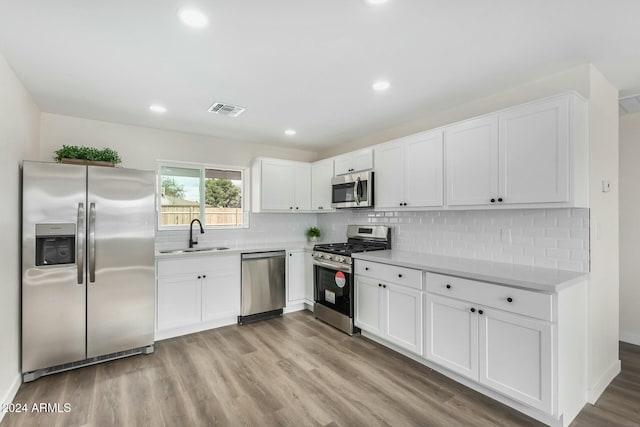 kitchen featuring light hardwood / wood-style floors, sink, white cabinetry, and stainless steel appliances