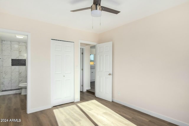 unfurnished bedroom with ceiling fan, dark hardwood / wood-style floors, a closet, and ensuite bath