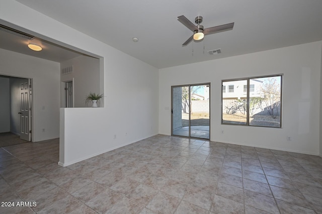 spare room with ceiling fan and light tile patterned flooring