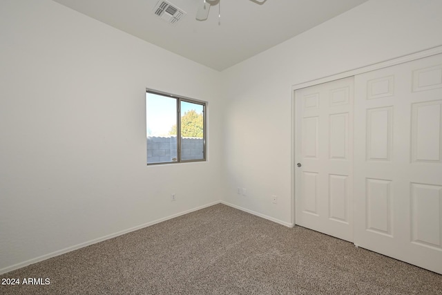 unfurnished bedroom featuring carpet floors, a closet, and ceiling fan