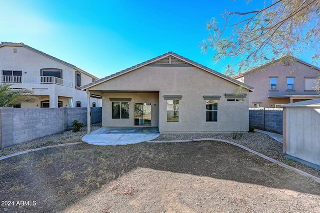 rear view of property featuring a patio area