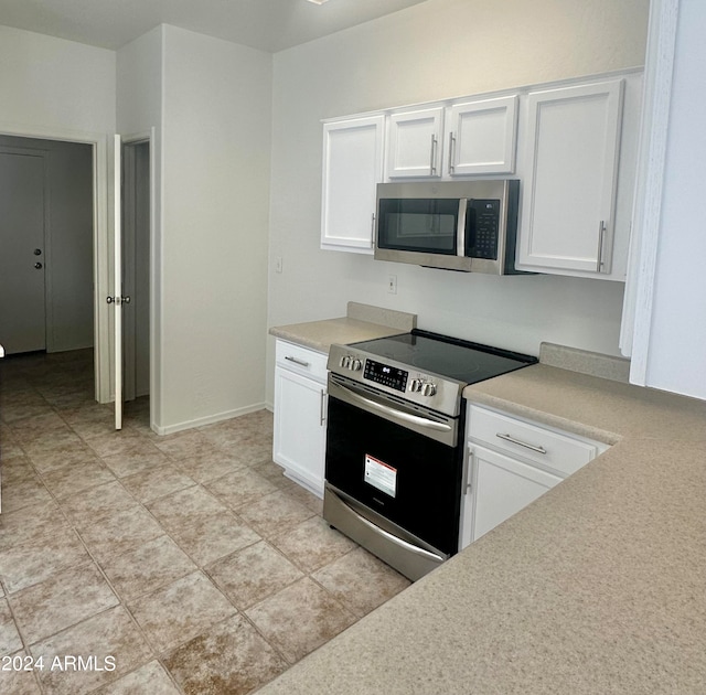 kitchen with white cabinetry and appliances with stainless steel finishes