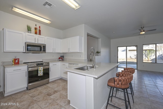 kitchen featuring white cabinetry, sink, ceiling fan, and stainless steel appliances