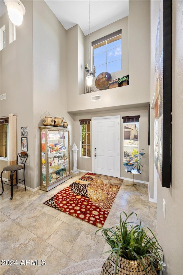 foyer entrance featuring a towering ceiling