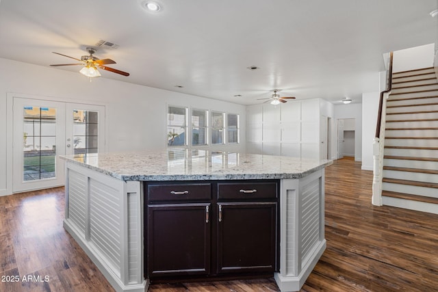 kitchen with dark hardwood / wood-style flooring, dark brown cabinetry, and a wealth of natural light