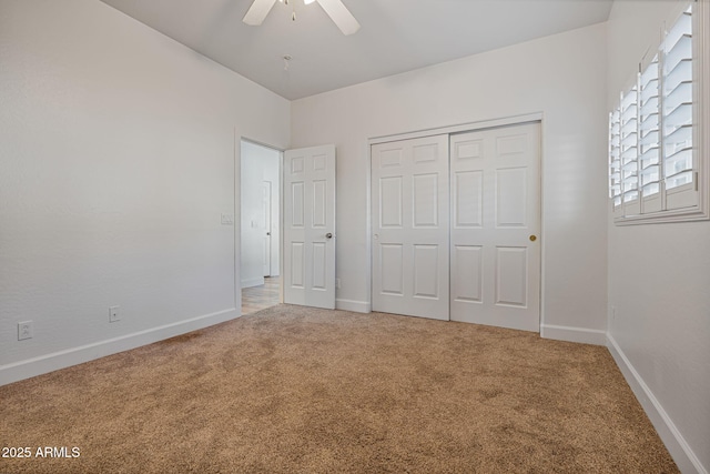 unfurnished bedroom featuring carpet flooring, ceiling fan, and a closet