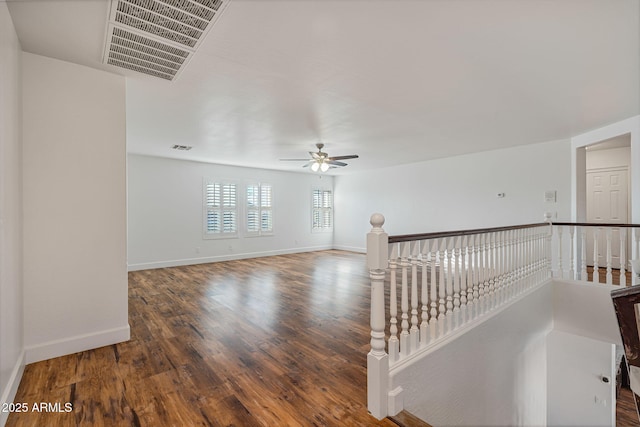 spare room with ceiling fan and dark hardwood / wood-style flooring