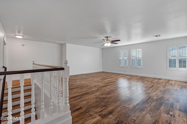 empty room featuring ceiling fan and dark wood-type flooring