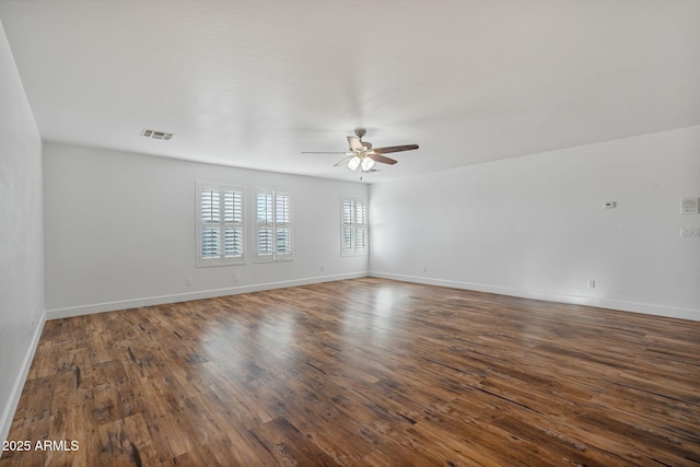 empty room with ceiling fan and dark hardwood / wood-style floors