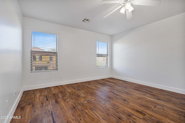 spare room featuring dark hardwood / wood-style floors and ceiling fan