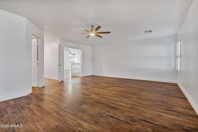 unfurnished room featuring dark hardwood / wood-style flooring, plenty of natural light, and ceiling fan