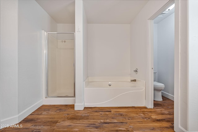 bathroom featuring separate shower and tub, hardwood / wood-style flooring, and toilet