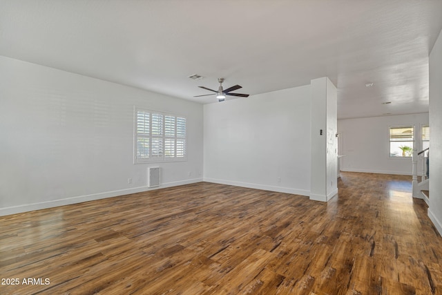 spare room featuring dark hardwood / wood-style floors and ceiling fan