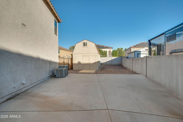 view of patio / terrace featuring central AC and a storage unit