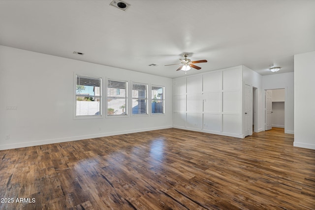 unfurnished living room with ceiling fan and dark wood-type flooring