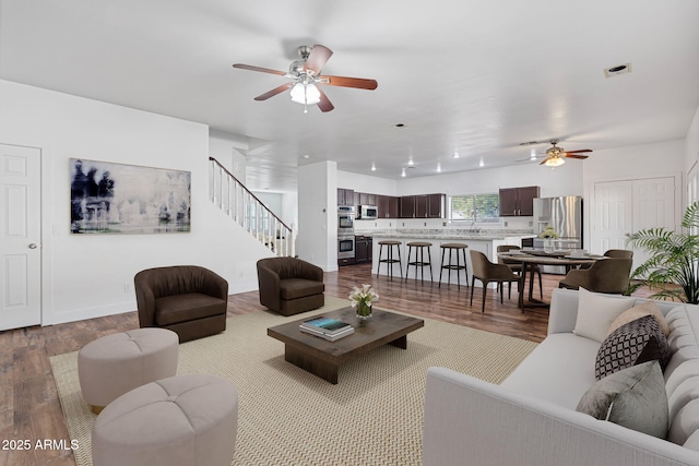 living room with ceiling fan and light wood-type flooring