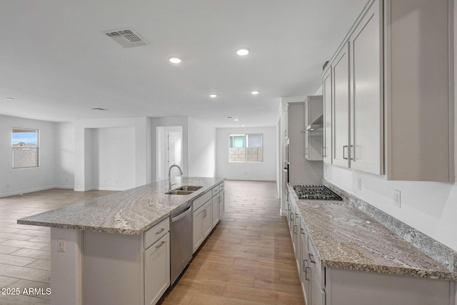 14789 W Lariat Ln, Surprise, AZ 85387 - kitchen featuring a sink, appliances with stainless steel finishes, a kitchen island with sink, healthy amount of natural light, and recessed lighting