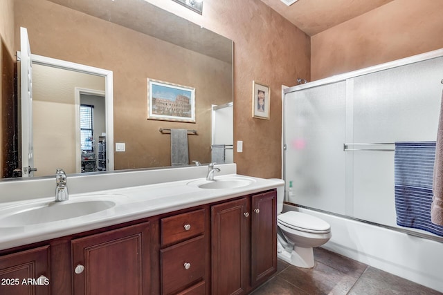 full bathroom featuring toilet, tile patterned floors, vanity, and bath / shower combo with glass door