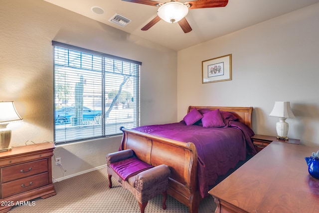 bedroom with ceiling fan and light carpet