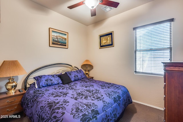 bedroom with multiple windows, ceiling fan, and carpet