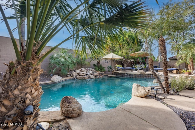 view of swimming pool with pool water feature