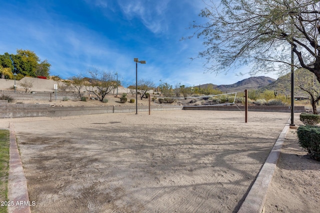 view of yard featuring a mountain view and volleyball court