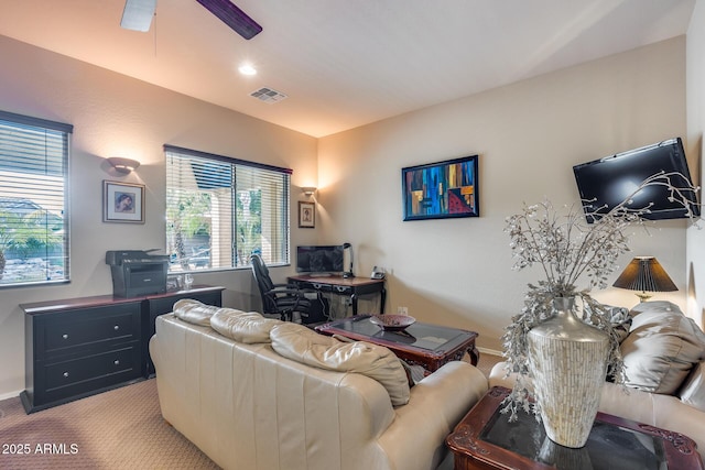 carpeted living room featuring ceiling fan