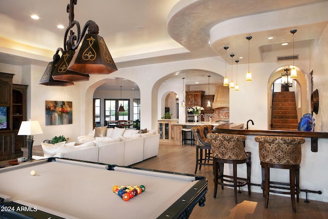 playroom featuring sink, dark hardwood / wood-style floors, a tray ceiling, and pool table