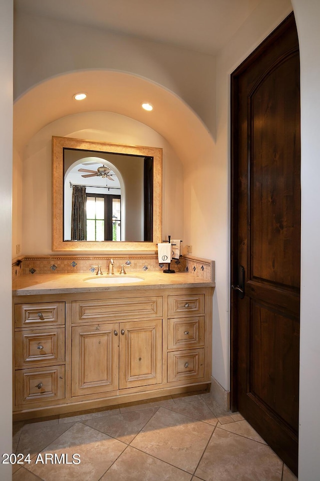 bathroom with tile patterned floors, decorative backsplash, ceiling fan, and vanity