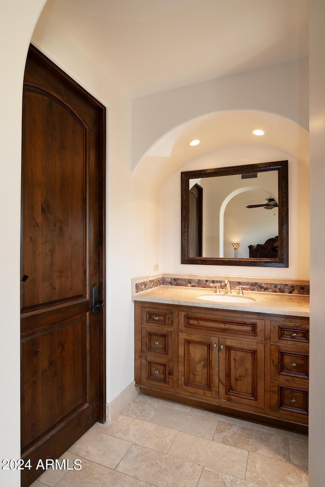 bathroom featuring ceiling fan and vanity