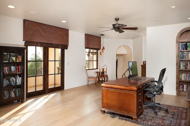 office space featuring french doors, light wood-type flooring, and ceiling fan