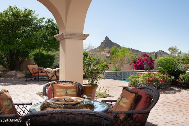 view of patio / terrace featuring a mountain view and a fenced in pool