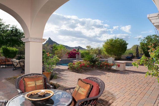 view of patio / terrace with a mountain view and a fenced in pool