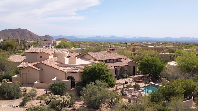 birds eye view of property with a mountain view