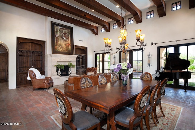 dining space with beamed ceiling, french doors, a towering ceiling, and a notable chandelier