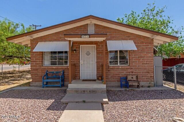 bungalow-style home with fence