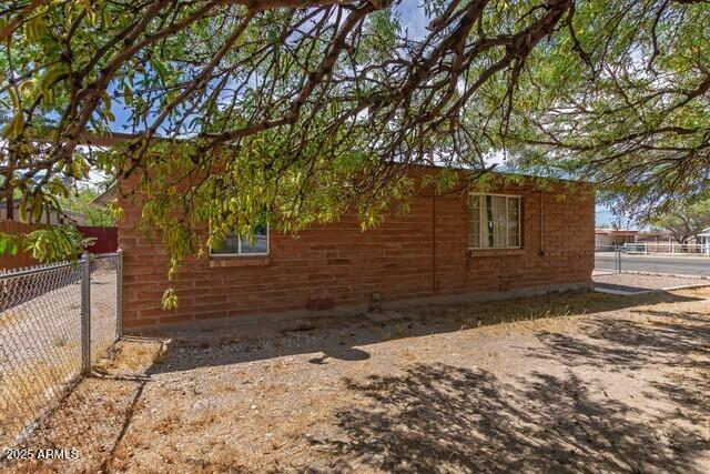view of side of property with fence