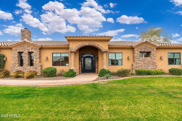 13206 N 64th St, Scottsdale, AZ 85254 - mediterranean / spanish-style home with stucco siding, a front yard, stone siding, a chimney, and a tiled roof