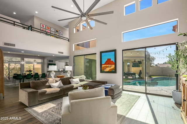 living room with plenty of natural light, hardwood / wood-style floors, and ceiling fan