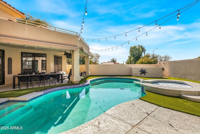 view of pool with a patio area and an in ground hot tub