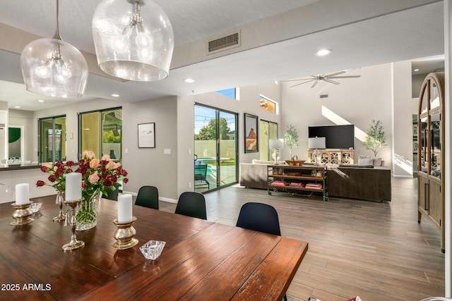 dining room with hardwood / wood-style flooring and ceiling fan