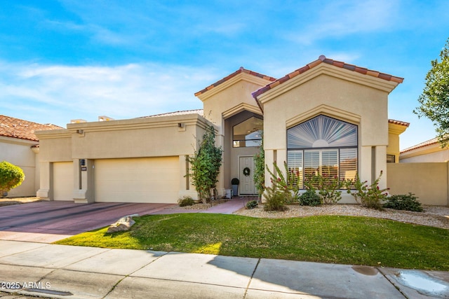 mediterranean / spanish-style home featuring a garage and a front yard